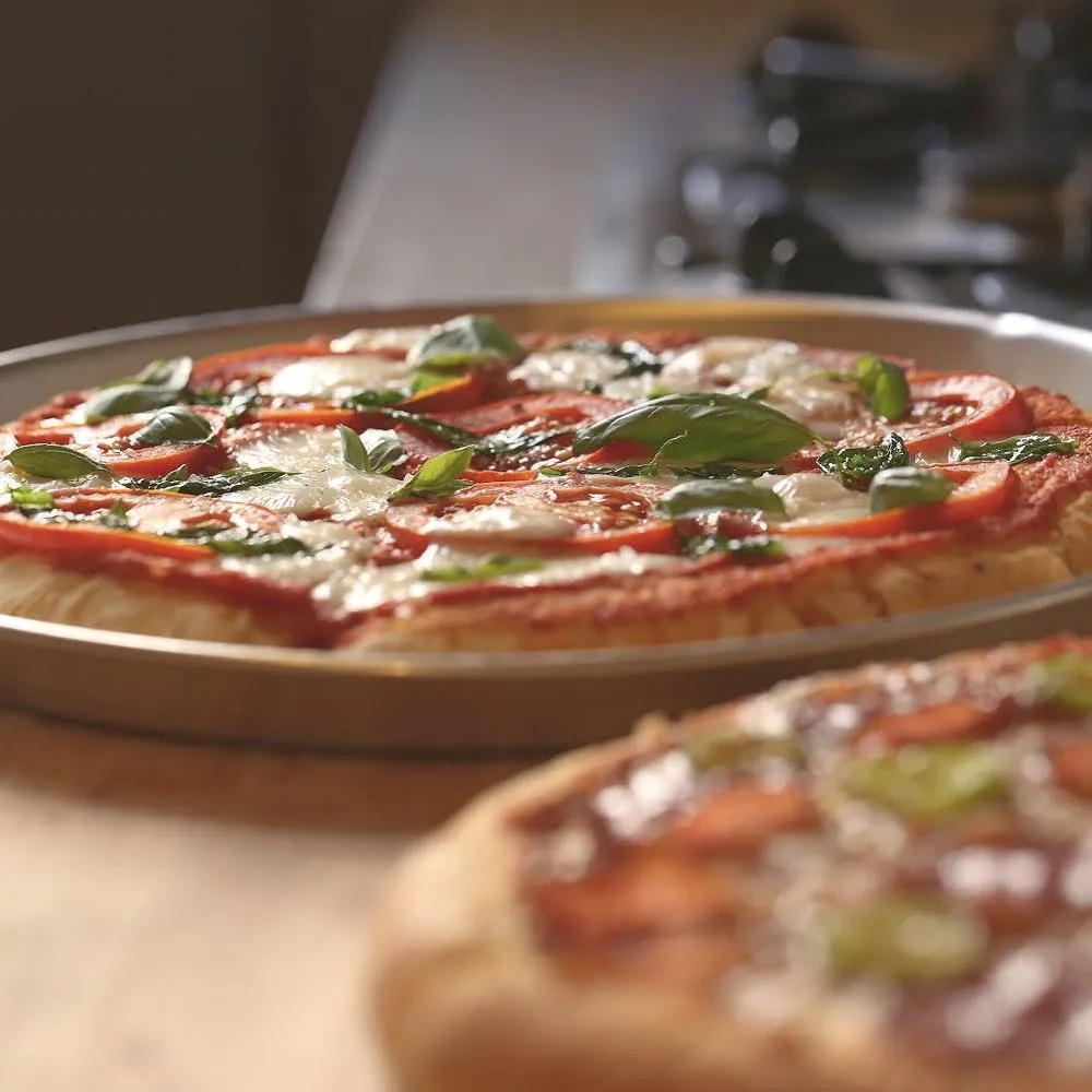Fully loaded pizza with pepperoni, green peppers, mushrooms, onions, ham, and bacon at Strathcona Pizza Edmonton